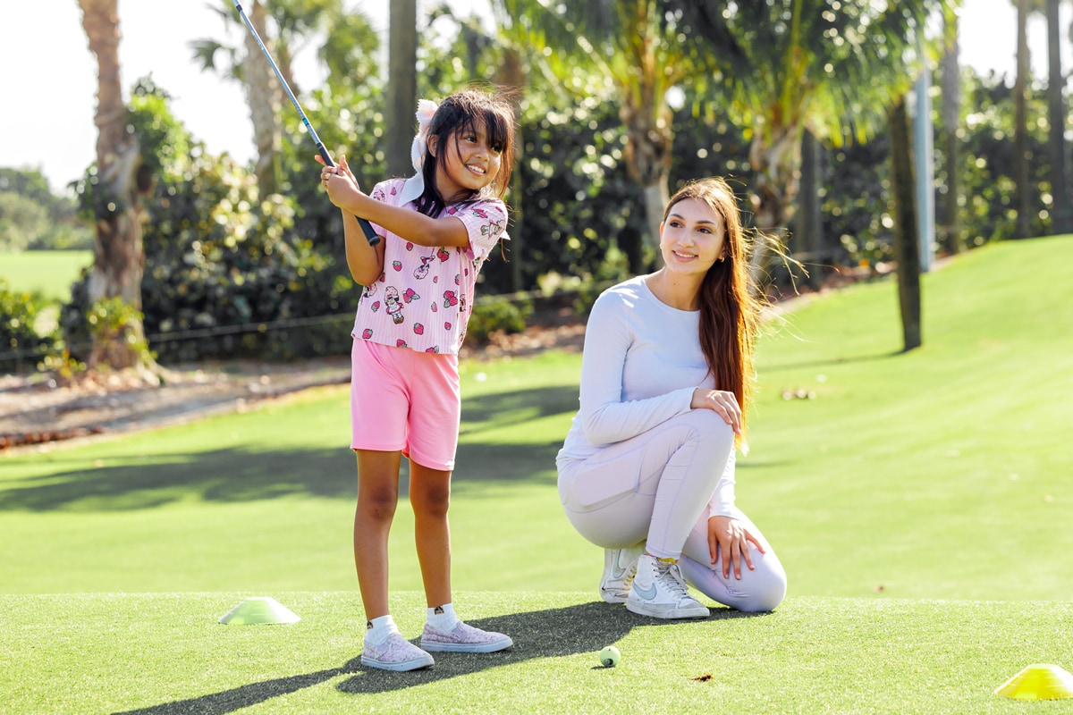 Girl learning to golf