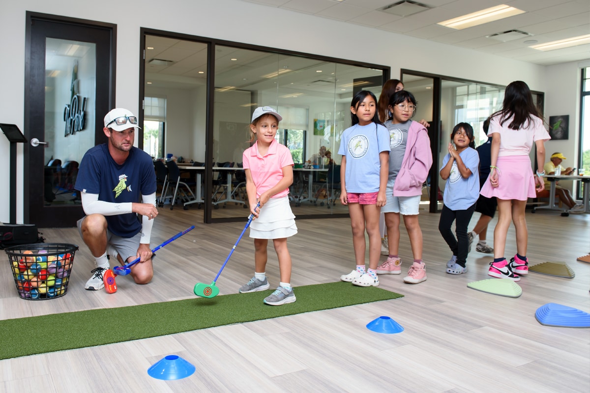Kids participating in indoor golf activities